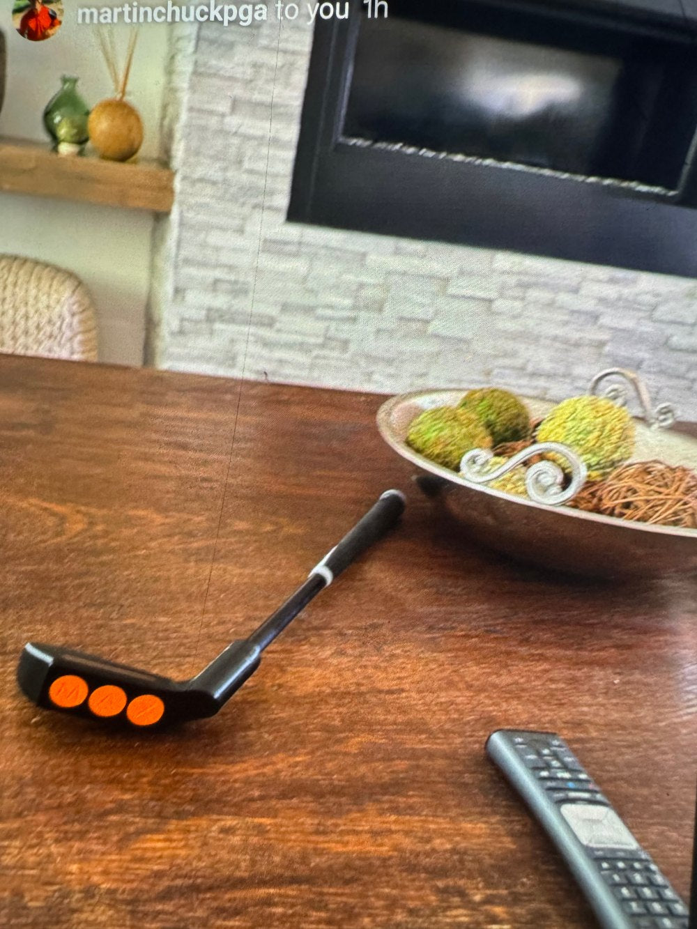 The Catalyst Max on a kitchen table next to the TV remote