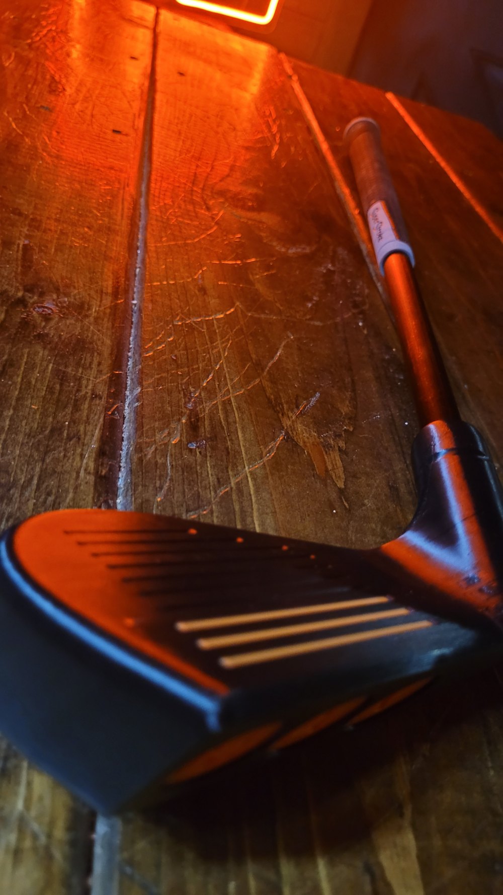 The Catalyst MAX on a wooden floor under neon light